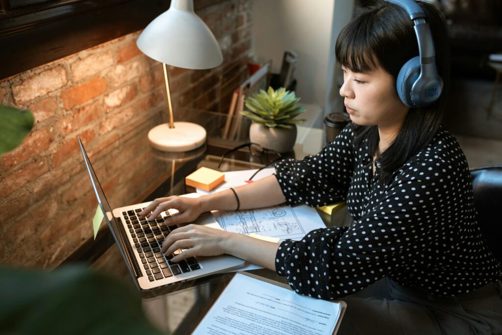 Custom web design showcased on a laptop by a girl